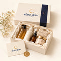 Elara Glow cream gift box with navy band, open with bottles and a card
